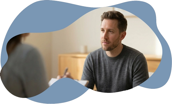 A man participating in a clinical consultation with a psychologist, representing a comprehensive
             mental health evaluation to identify root causes and provide a formal diagnosis for insurance and
             recovery.